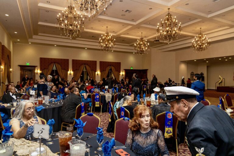 Guests gathered at tables in the chandelier-lit ballroom at the 2025 Antelope Valley Military Ball