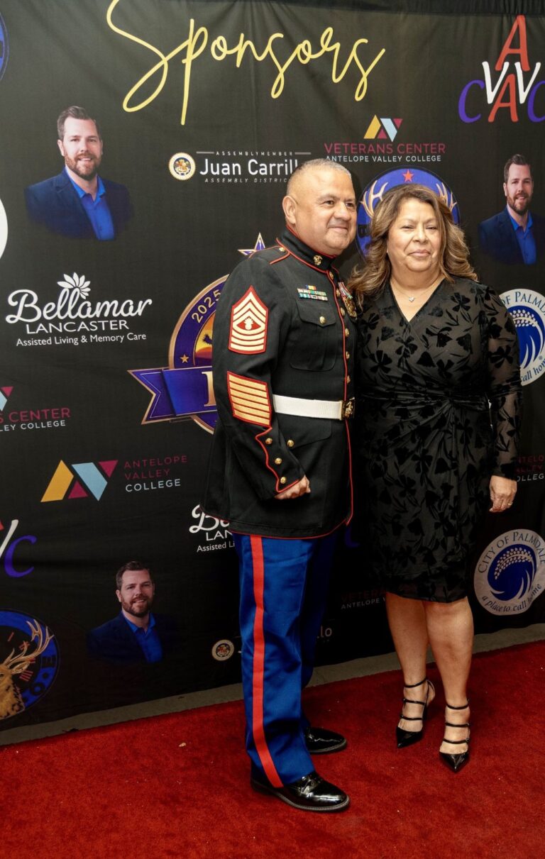 Marine in dress blues and his guest on the red carpet at the 2025 Military Ball